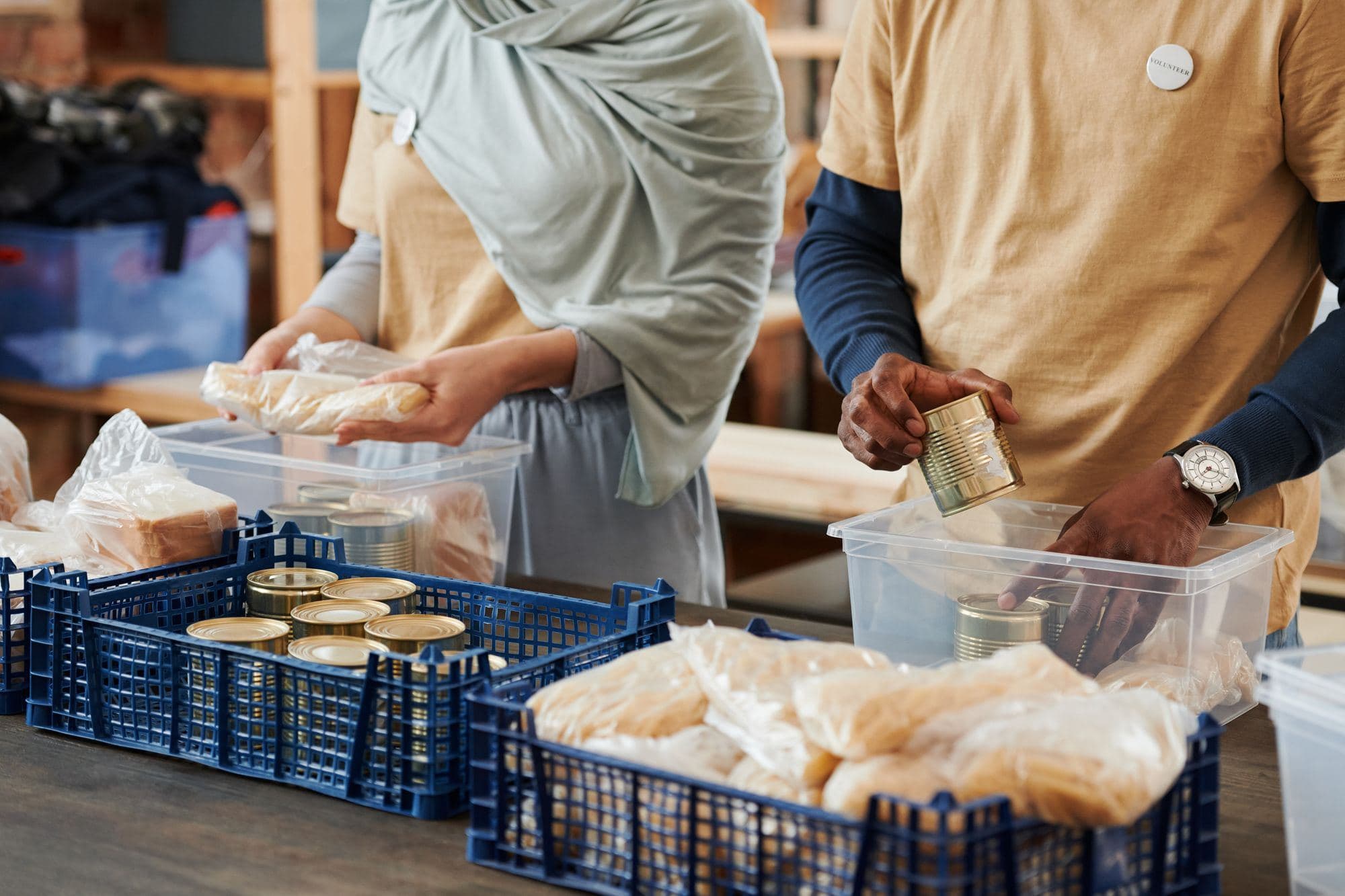 Volunteers packing bread and canned food into donation crates